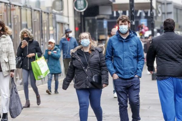 people walking with masks on