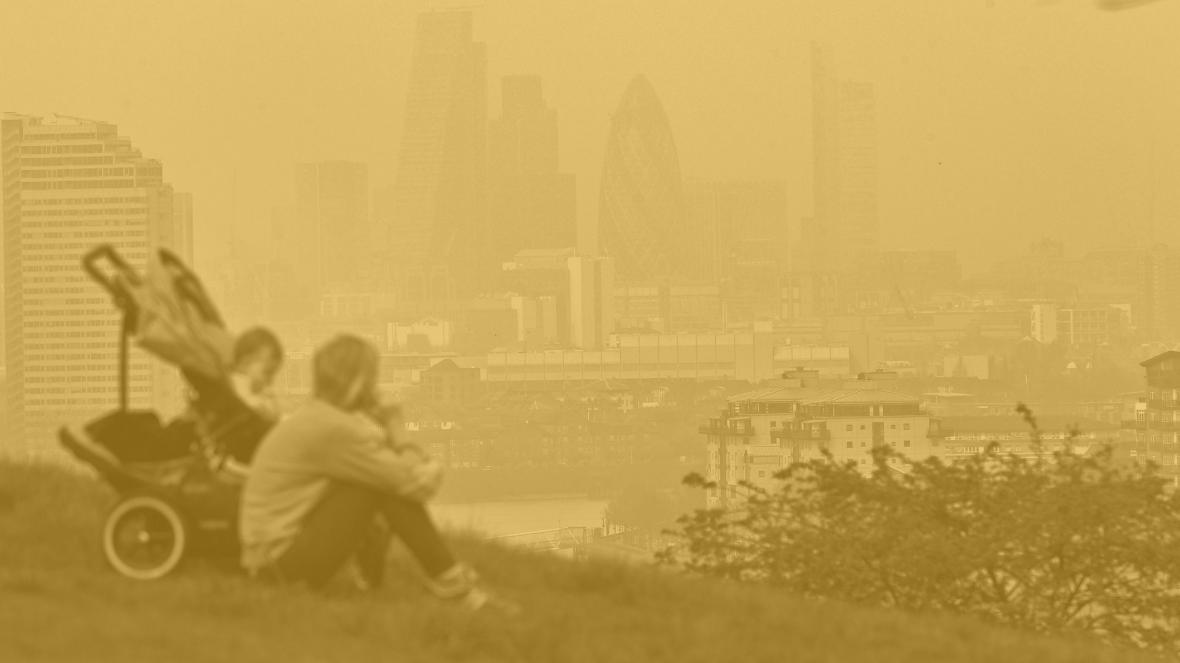 Person overlooking polluted London cityscape